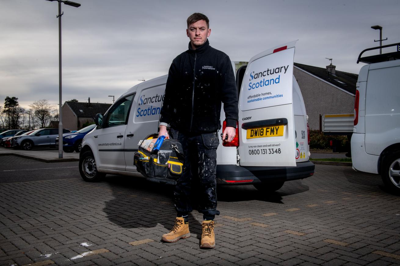 Sanctuary Scotland maintenance worker standing in front of his van