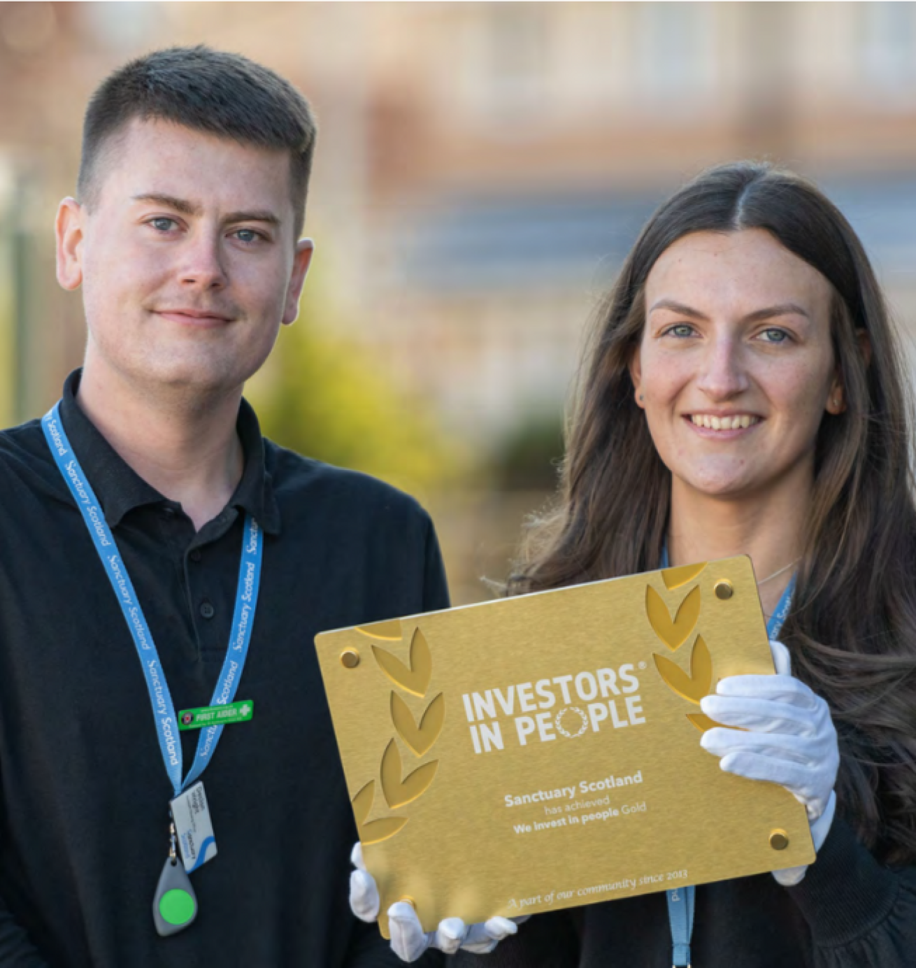 Assistant Housing Officer Declan and Housing Officer Rachel holding the IIP Award Plaque